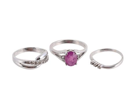 
	
		THREE GEM SET RINGS
		The first set with a line of brilliant cut diamonds to bifurcated crossover shoulders, stamped 750