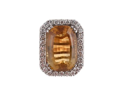 
	
		A CITRINE AND DIAMOND DRESS RING
		The cushion shaped citrine within a brilliant cut diamond surround, to a later gold h