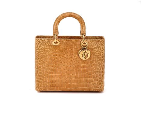 
	
		Y&nbspDIOR, LADY DIOR, A LARGE MUSTARD CROCODILE HANDBAG 
		CIRCA 2010
		With twin loop handles, gold tone hardware, gol