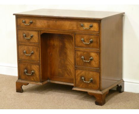 Reproduction figured mahogany George II style knee hole desk/dressing table, fitted with seven oak lined drawers and centre c