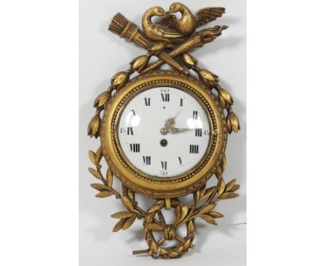 A Louis XV style wall clock, with giltwood surround of birds, torches and foliage, the white enamel dial fitted an eight-day 