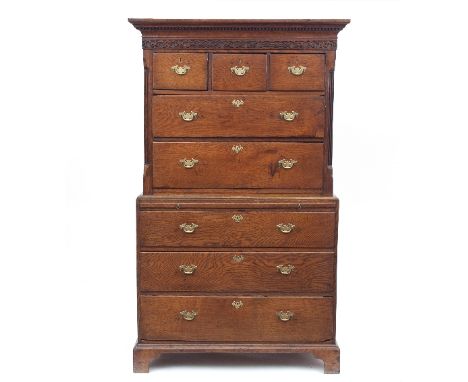 A mid 18th Century American tallboy chest with dentil moulded cornice and blind fret frieze, fluted columns to the sides, fit