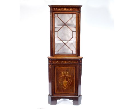 An Edwardian mahogany inlaid corner cupboard, the glazed upper section above a cupboard door inlaid a vase, on bracket feet, 