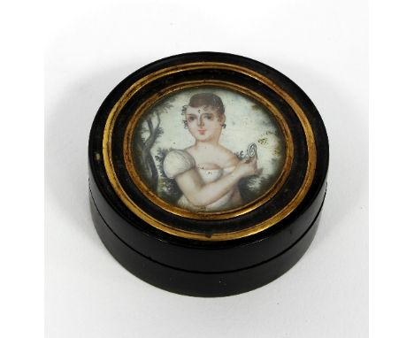 An early 19th Century tortoiseshell box of circular shape, the cover set with a portrait of a young woman in a white dress, 6