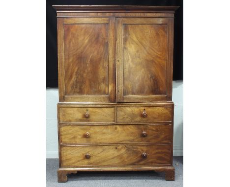 A late Regency mahogany linen press, the top fitted sliding trays enclosed by a pair of panel doors with two long and two sho