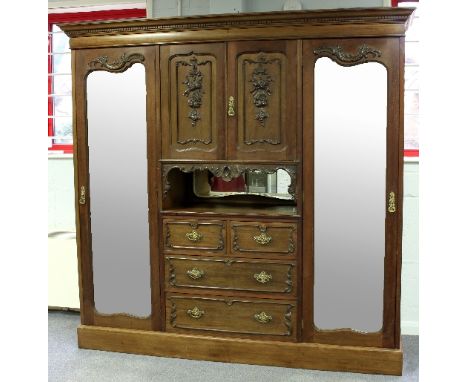 A Victorian mahogany compactum wardrobe, manufactured by Blyth & Sons., the dentil cornice above twin mirrored panel doors en