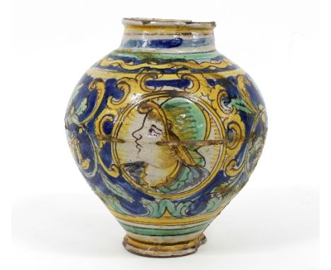 A 16th Century Italian majolica albarello, decorated a face in profile within a circular reserve on a ground of blue, yellow 