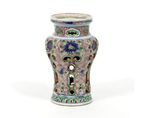 A Chinese wucai censer stand of baluster form with pierced outer surface decorated with flowers on a scale ground, 19cm high 