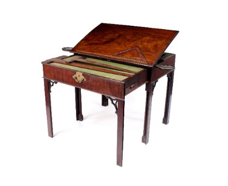 A George III architect's mahogany table, the drawer with writing slide, fitted interior and candle stands to the sides, with 