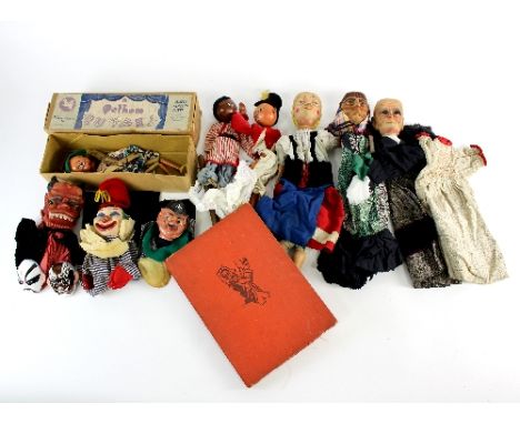 Six hand puppets, four with carved heads, a boxed Pelhams Puppets Ltd. string puppet, two other string puppets, two Oriental 