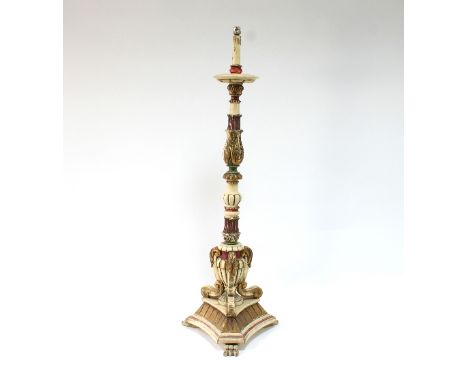 An Italian altar-type candlestick on a flat triform base, with claw feet, 145cm high