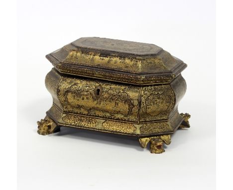 A 19th Century Cantonese black and gold lacquer tea caddy of sarcophagus shape, on four carved mask head feet, the interior f