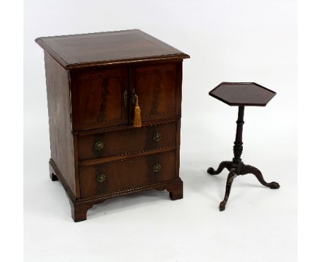 A mahogany commode with two panel doors above two graduated drawers and a mahogany tripod table, 56cm wide