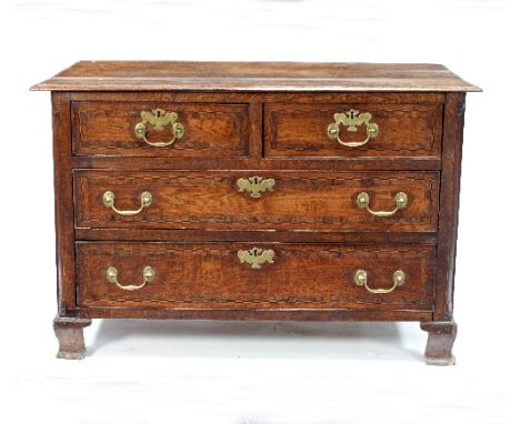 An 18th Century oak chest, the triple-plank top above two short and two long drawers, the front inlaid chequer stringing, on 