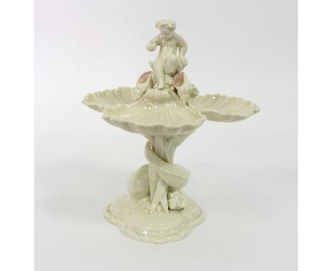 A Royal Worcester figural tazza, modelled as three scallop shells surmounted by a boy on a stem of bulrushes with entwined do