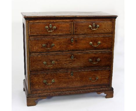 A George III oak and crossbanded chest of two short over three long drawers on bracket feet, 103.5cm wide