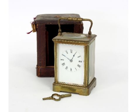An eight-day carriage clock in a gilt brass case, with plain enamel dial and Roman numerals, 18cm high and the travelling cas