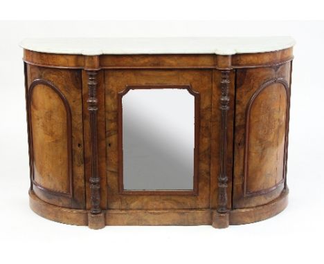 A mid Victorian walnut D-shaped side cabinet with marble top, panelled cupboards to the ends and a central mirrored door, 136