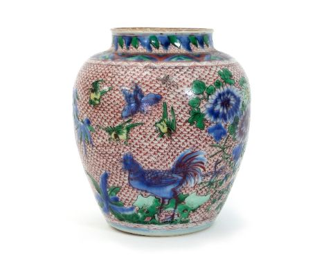 A Chinese wucai jar, 17th Century, painted with birds and chrysanthemums on a red scale ground, 22cm high/see illustration   