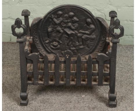 A small cast iron fire grate with decorative back plateHx43cmWx47cmDx27cm  