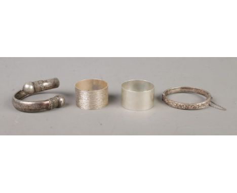 A collection of silver oddments, to include hinged bangle and two napkin rings. Total weight: 79.6g.  