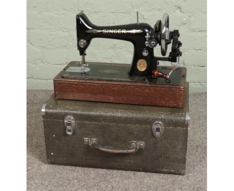 A vintage Singer Sewing machine in faux crocodile skin case  