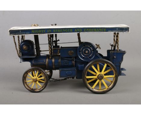 A model steam engine painted in white and blue with motto 'Mighty in Strength and Endurance, length 31cm approx.  