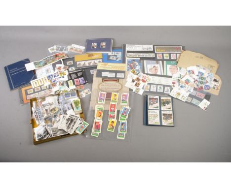 A collection of stamps, cards and similar items. To include a large quantity of unfranked stamps, some in presentation packs,