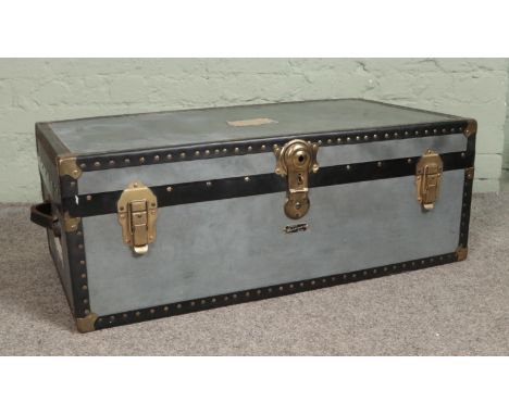A Mossman Made metal travel trunk, with studded edges. Height: 33cm, Width: 90cm, Depth: 52cm.  