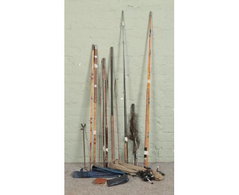 A quantity of vintage fishing equipment, including intrepid reels, cane stake, fly case and cane rods.  