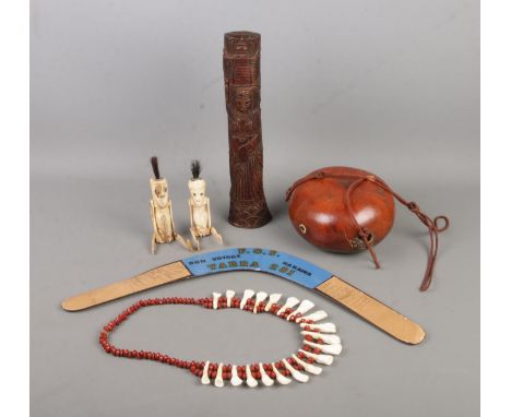 A collection of Aboriginal and tribal art to include carved bone jointed figures, multi-signed boomerang marked F.O.S Yarra 2