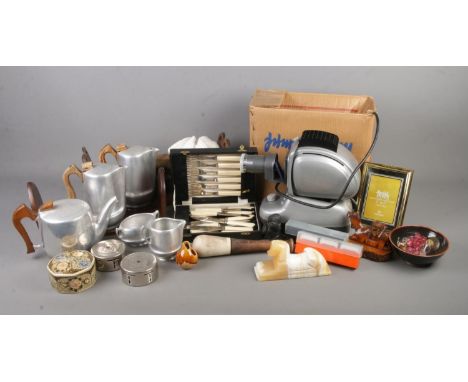 An assorted mix of collectables including a Noris projector, Piquet Ware ands similar teawares, adjustable book slides, Midla