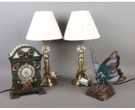 A collection of table lamps to include stained glass butterfly and mantle clock.  