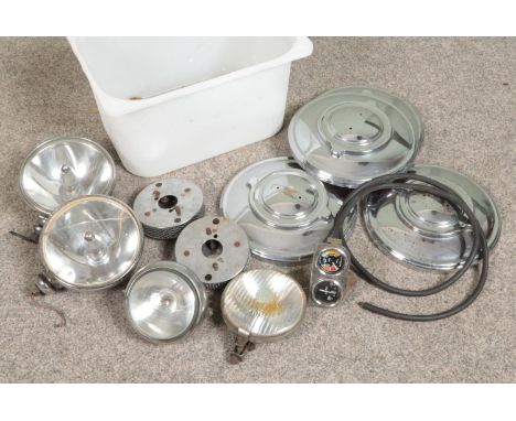 A box of vintage car parts. Includes Marchal, Lucas SLR 700S, Lumax, four hubcaps and a Smiths vacuum gauge.  