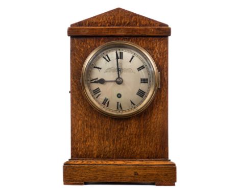 *RAF Clock. A WWII period RAF station mantel clock,  the silvered circular dial with black roman numerals and hands, RAF wing