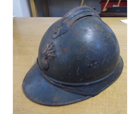*Helmet. A WWI French Army M-15 Adrian helmet,  with RF grenade badge, the underside of the peak engraved with initials 'BE' 
