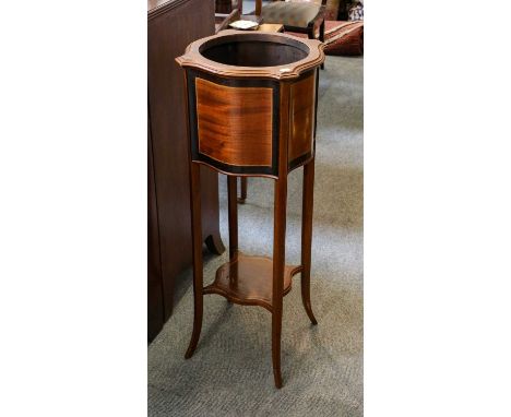 An Edwardian inlaid mahogany planter raised on square tapering supports and with a shaped under-tier, 33cm square by 99cm