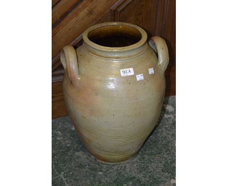 A large French two handled pottery preserve jar used for preserving salted hams.