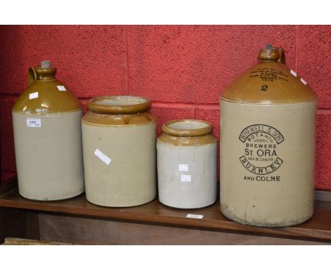 A Whewell & Sons Brewery of Burnley large stoneware jar; another, smaller, unlabelled; two small stoneware jars (4)