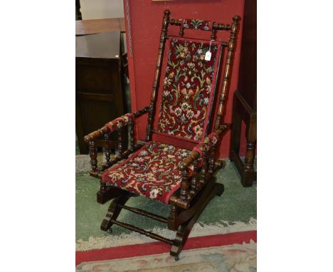 An American Rocking Chair, bobbin turned columns, floral upholstered back and seat