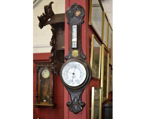 An early 20th century George IV carved oak banjo barometer/thermometer, retailed by W H May Goldsmiths, Nottingham, white cer