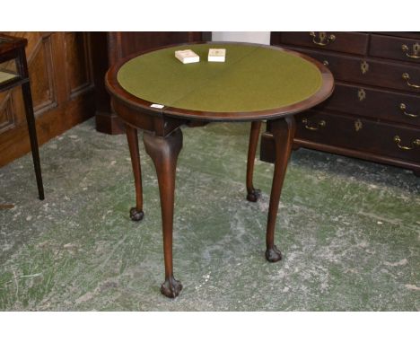 A mahogany demi-lune card table, folding top enclosing green baize playing surface, tapering supports, ball and claw feet