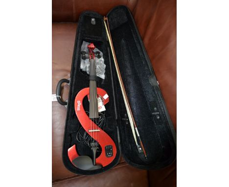 A Stagg electric violin outfit, comprising a full size electric violin in metallic red, bow, and a case.