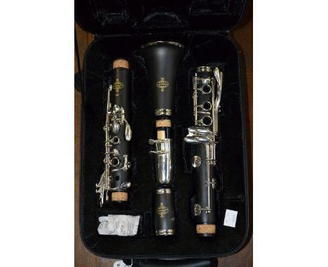 A Buffet Crampon Clarinet, model number B12, cased, a conductors' baton with gemwood handle, boxed, and a penny whistle by 'g
