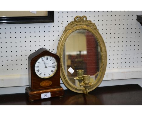 An Edwardian mahogany mantel clock, retailed by Payne & Co, London; a brass mirrored wall sconce (2) 