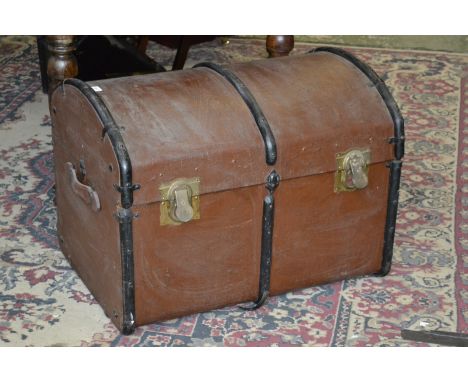 An early 20th century leather bound domed top travelling trunk, c.1900