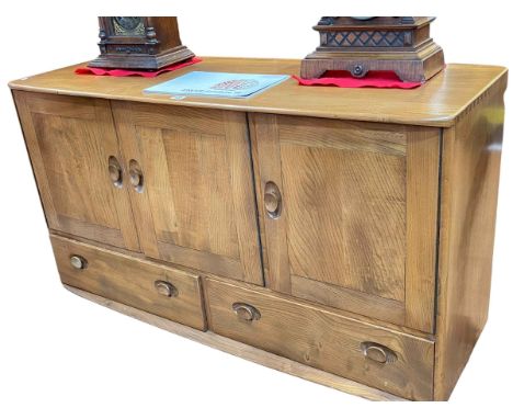 Ercol Windsor three door sideboard, 76cm by 130cm by 50cm.