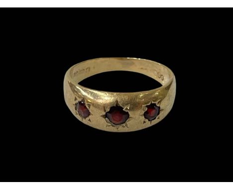 Three stone garnet ring set in 9 carat gold, size Q.
