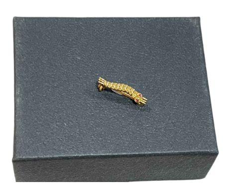 A WWII caterpillar club brooch in gold?, ruby/garnet cabochon set eyes, engraved to the reverse 'P/L. J. P. KELLY', with a se