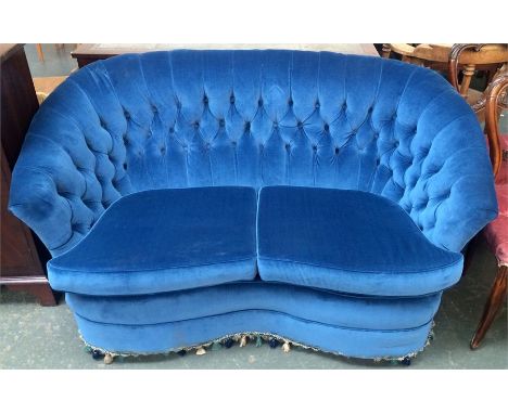 A button back two seater sofa upholstered in blue velvet